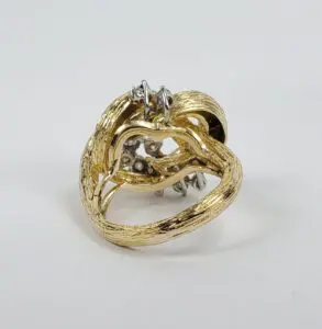 Gold ring with heart-shaped design.
