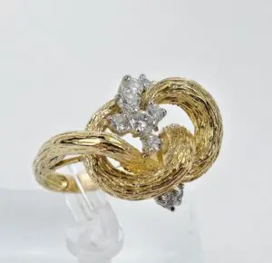 Gold knot ring with diamond accents.