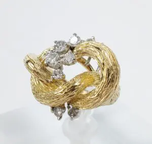 Gold ring with diamonds and textured design.