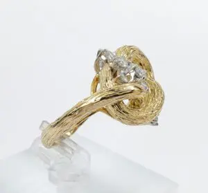 Gold knot ring with diamond accents.