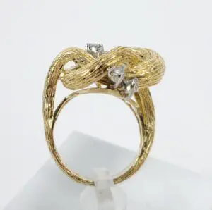 Gold textured ring with diamond accents.