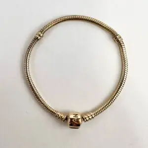Gold bracelet with engraved clasp on display.