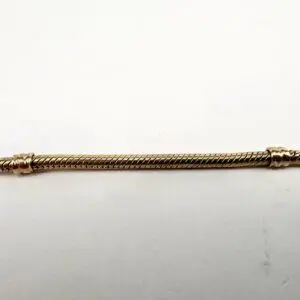 Gold twisted metal rod on white background.