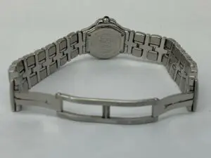 Silver watch with engraved metal bracelet.
