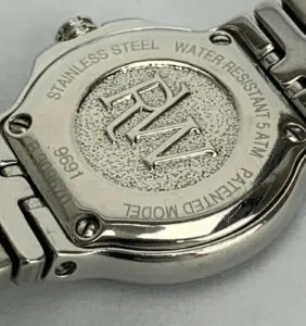 Back of stainless steel wristwatch with engraving.