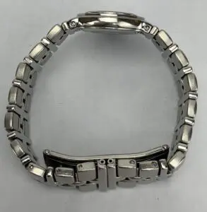 Silver metal watch band on white background.