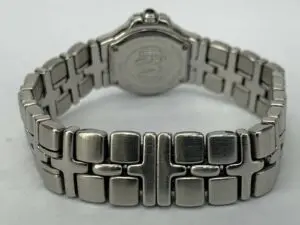 Silver watch with intricate metal bracelet.