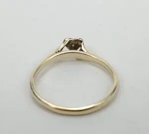 Gold ring with heart-shaped setting.