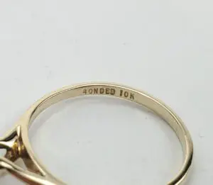 Gold ring engraved with "Bonded 10K.