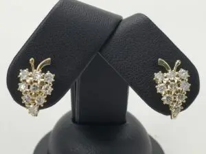 Gold and diamond grape cluster earrings display.