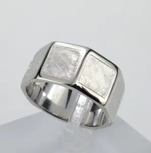 Silver ring with textured square design.