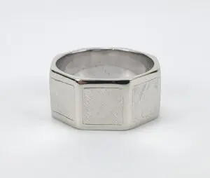 Silver hexagonal ring with textured design.