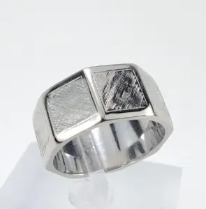 Silver ring with textured geometric design.