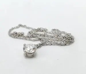 Silver necklace with a diamond pendant.