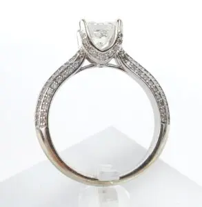 Silver ring with diamond and intricate design.