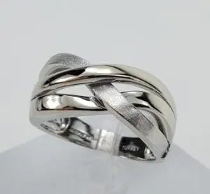 Silver intertwined design ring on display.