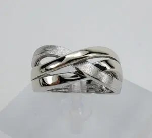Silver intertwined band ring on display.