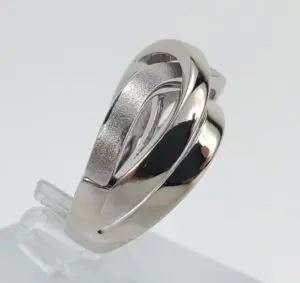 Silver ring with modern, intertwined design.