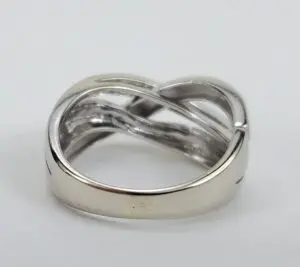 Silver twisted band ring on display.
