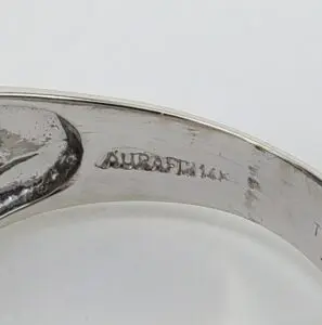 Silver ring with engraved inscription inside band.