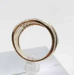 Gold ring with intricate engraved details.
