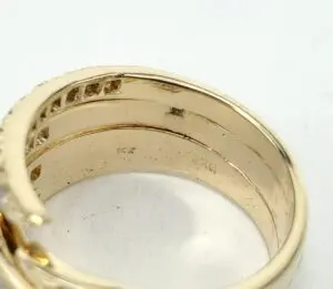Gold ring with engraved markings, inner view.
