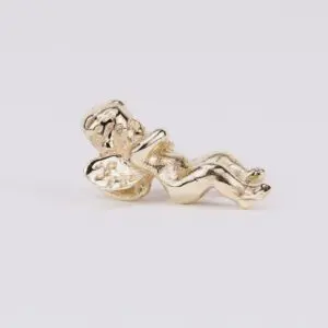Gold angel figurine lying on side.