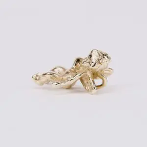 Gold dragonfly on white background.