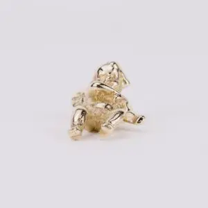 Small gold figurine of a seated bear.