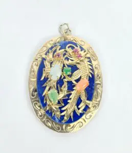 Ornate gold pendant with colorful gemstones.