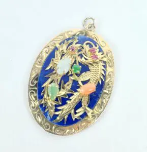 Ornate gold pendant with colorful gemstones.
