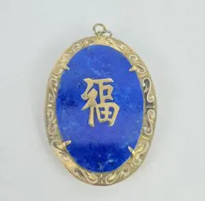 Blue pendant with gold Chinese character.