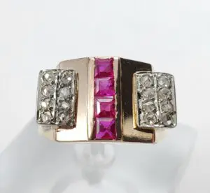 Gold ring with diamonds and pink stones.