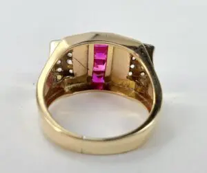 Gold ring with pink gemstones inside.