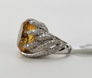 Diamond ring with large yellow gemstone.