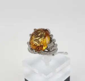 Silver ring with large yellow gemstone.