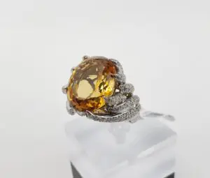 Ornate ring with large amber gemstone.