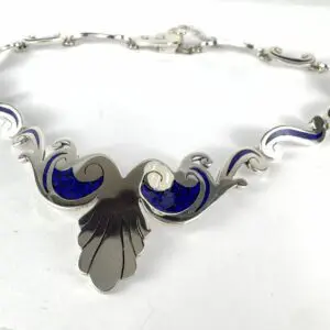 Silver necklace with blue enamel accents.