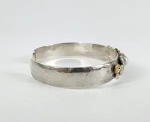 Silver bracelet with decorative embellishments.