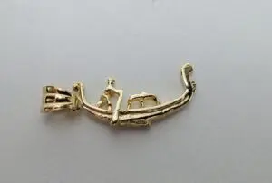 Gold pendant with abstract design.