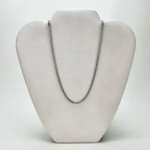Silver chain necklace on display stand.