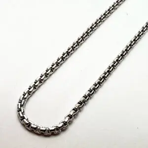 Silver chain necklace on white background.