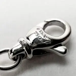 Silver lobster clasp with engraved markings.