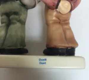 Figurines labeled "Duett" on a base.