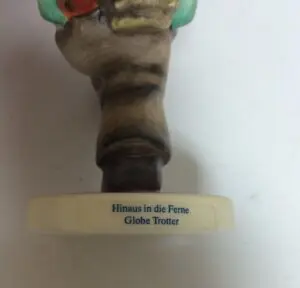 Figurine base with German text inscription.
