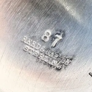 Sterling silver stamp with number and text.