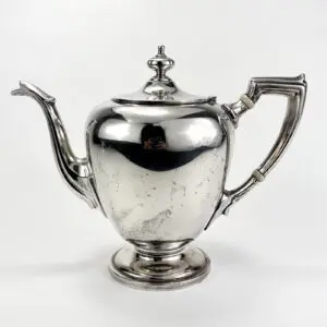 Silver teapot with elegant curved handle.