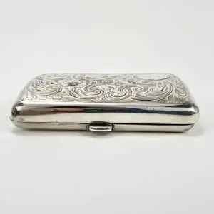 Ornate silver cigarette case with engravings.