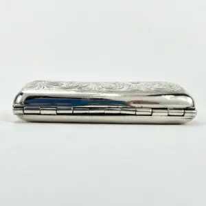 Ornate silver case with floral engraving.