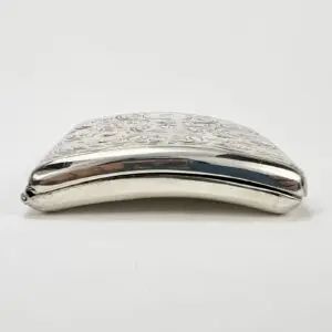Silver decorative metal case with embossed design.